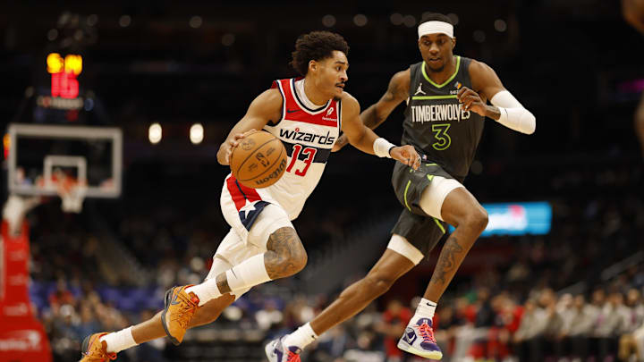 Jan 13, 2025; Washington, District of Columbia, USA; Washington Wizards guard Jordan Poole (13) drives to the basket as Minnesota Timberwolves forward Jaden McDaniels (3) defends in the second quarter at Capital One Arena. Mandatory Credit: Geoff Burke-Imagn Images