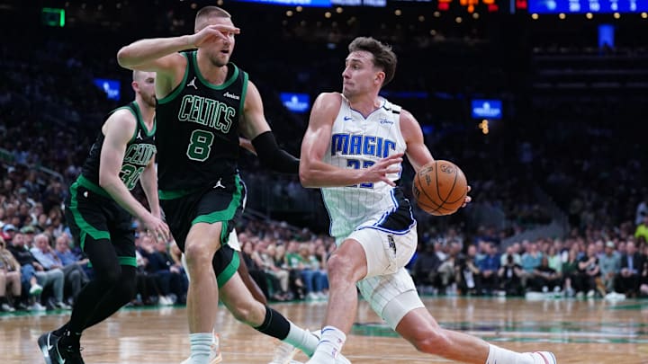 Orlando Magic forward Franz Wagner drives the ball against Boston Celtics center Kristaps Porzingis. Orlando Magic forward Franz Wagner drives the ball against Boston Celtics center Kristaps Porzingis.