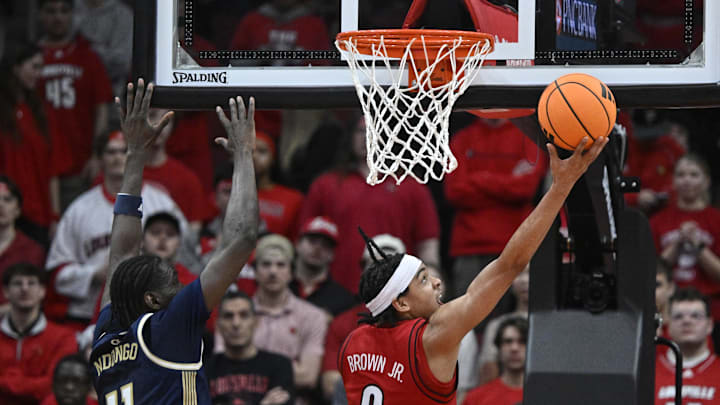 Feb 21, 2026; Louisville, Kentucky, USA; Louisville Cardinals guard Mikel Brown Jr. (0) shoots against Georgia Tech Yellow Jackets forward Baye Ndongo (11) during the first half at KFC Yum! Center. Mandatory Credit: Jamie Rhodes-Imagn Images Feb 21, 2026; Louisville, Kentucky, USA; Louisville Cardinals guard Mikel Brown Jr. (0) shoots against Georgia Tech Yellow Jackets forward Baye Ndongo (11) during the first half at KFC Yum! Center. Mandatory Credit: Jamie Rhodes-Imagn Images