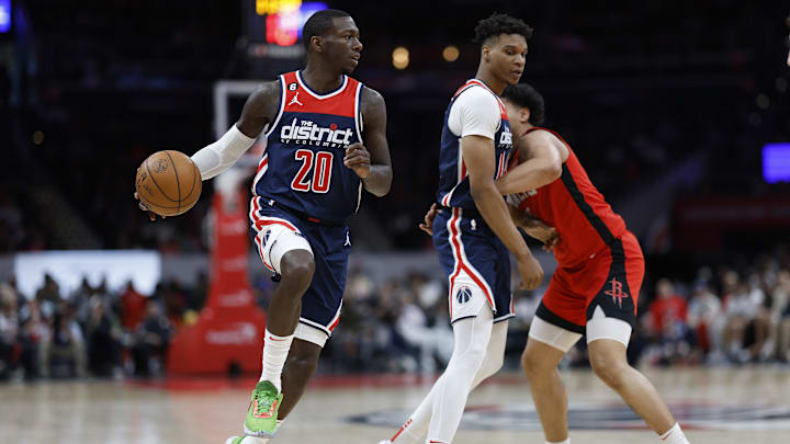Apr 9, 2023; Washington, District of Columbia, USA; Washington Wizards guard Kendrick Nunn (20) dribbles the ball past Houston Rockets guard Daishen Nix (15) and Wizards forward Isaiah Todd (14) in the fourth quarter at Capital One Arena. Mandatory Credit: Geoff Burke-Imagn Images