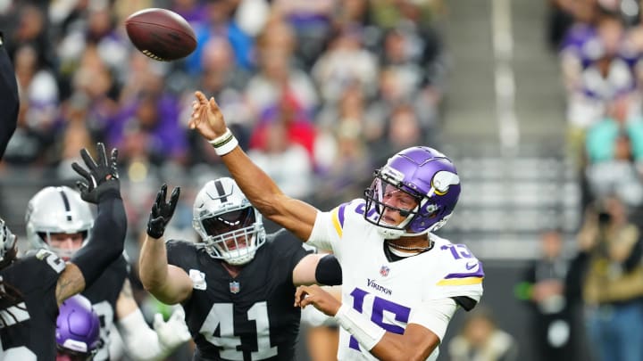 Dec 10, 2023; Paradise, Nevada, USA; Minnesota Vikings quarterback Joshua Dobbs (15) throws under pressure from Las Vegas Raiders linebacker Robert Spillane (41) during the second quarter at Allegiant Stadium. Mandatory Credit: Stephen R. Sylvanie-USA TODAY Sports