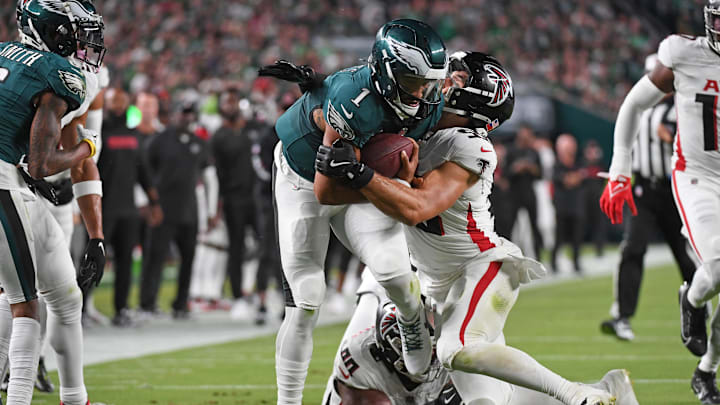 Sep 16, 2024; Philadelphia, Pennsylvania, USA; Philadelphia Eagles quarterback Jalen Hurts (1) is tackled by Atlanta Falcons linebacker Kaden Elliss (55) during the second quarter at Lincoln Financial Field. Mandatory Credit: Eric Hartline-Imagn Images