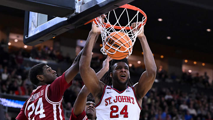 Mar 22, 2025; Providence, RI, USA; St. John's Red Storm forward Zuby Ejiofor (24) dunks against Arkansas Razorbacks forward Billy Richmond III (24) and guard Johnell Davis (1) during the second half of a second round men’s NCAA Tournament game at Amica Mutual Pavilion. Mandatory Credit: Brian Fluharty-Imagn Images
