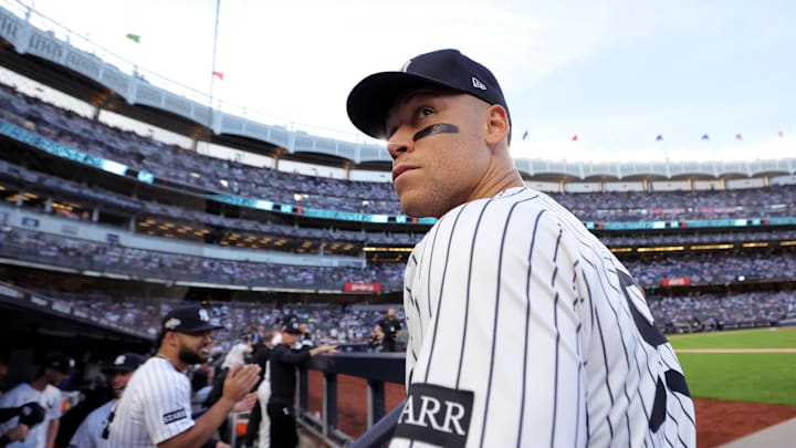 Sep 30, 2025; Bronx, New York, USA; New York Yankees right fielder Aaron Judge (99) looks into the stands from the dugout before taking the field for game one of the Wildcard round of the 2025 MLB playoffs against the Boston Red Sox at Yankee Stadium. Mandatory Credit: Brad Penner-Imagn Images