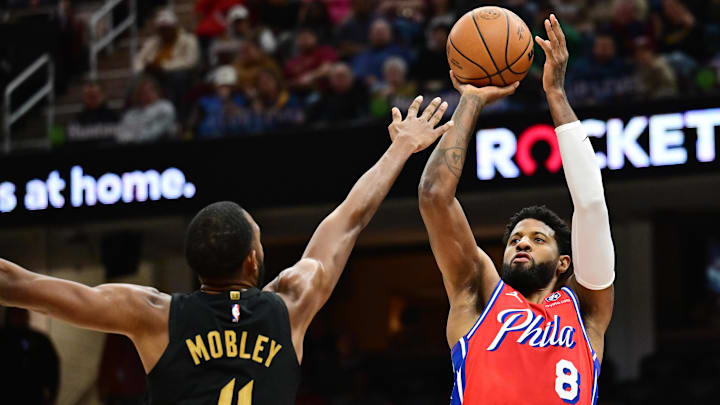 Dec 21, 2024; Cleveland, Ohio, USA; Philadelphia 76ers forward Paul George (8) shoots over the defense of  Cleveland Cavaliers forward Evan Mobley (4) during the first half at Rocket Mortgage FieldHouse. Mandatory Credit: Ken Blaze-Imagn Images