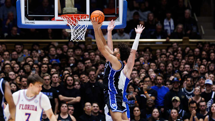 Duke Blue Devils forward Cameron Boozer (12) shoots over Florida Gators forward Alex Condon (21) during the second half at Cameron Indoor Stadium in Durham, NC on Tuesday, December 2, 2025. [Matt Pendleton/Gainesville Sun]