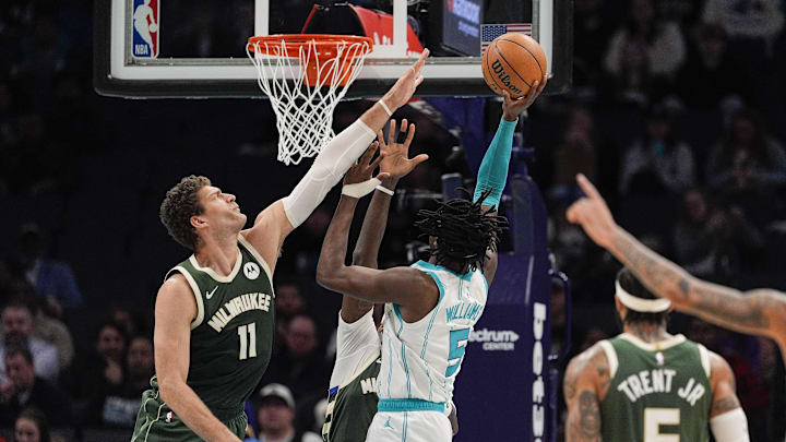 Feb 5, 2025; Charlotte, North Carolina, USA; Charlotte Hornets center Mark Williams (5) goes to the basket against Milwaukee Bucks center Brook Lopez (11) during the second quarter at Spectrum Center. Mandatory Credit: Jim Dedmon-Imagn Images