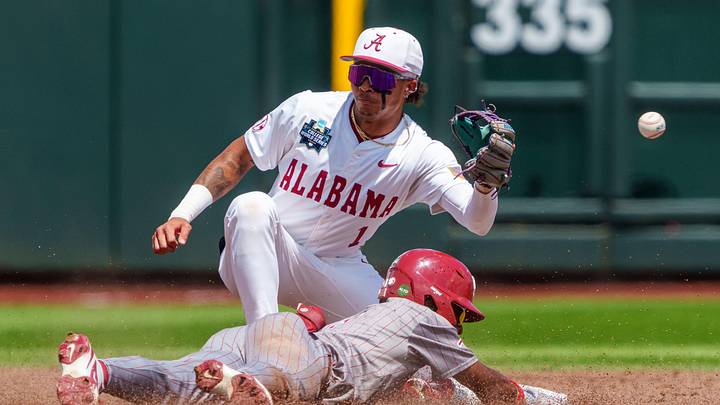 Jun 13, 2026; Omaha, NE, USA; Oklahoma Sooners center fielder Jason Walk (1) steals second against Alabama Crimson Tide shortstop Justin LeBron (1) during the third inning at Charles Schwab Field. Mandatory Credit: Dylan Widger-Imagn Images