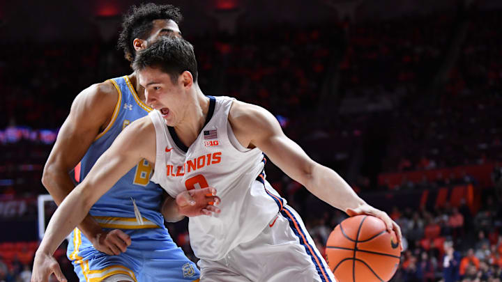 Dec 29, 2025; Champaign, Illinois, USA;  Illinois Fighting Illini forward David Mirkovic (0) drives the ball against Southern University Jaguars forward Malek Abdelgowad (8) during the first half at State Farm Center. Mandatory Credit: Ron Johnson-Imagn Images