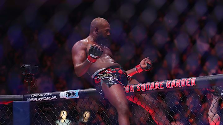 Nov 16, 2024; New York, NY, USA; Jon Jones (red gloves) celebrates defeating Stipe Miocic (blue gloves) in the heavyweight bout during UFC 309 at Madison Square Garden. Mandatory Credit: Brad Penner-Imagn Images