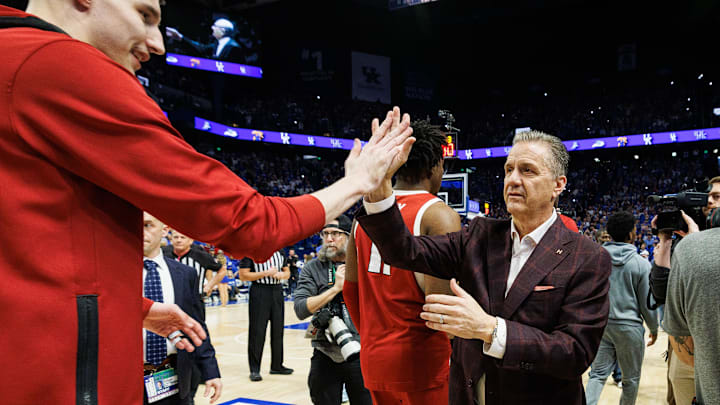 Arkansas coach John Calipari high-fives forward Zvonimir Ivisic before the game against Kentucky at Rupp Arena.