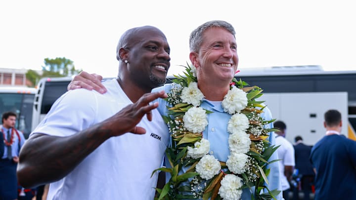 Aug 31, 2024; Tucson, Arizona, USA; Arizona Wildcats head coach Brent Brennan takes picture with Arizona Wildcats honorary captain former cornerback Chris McAlister at the Wildcat Walk before the game at Arizona Stadium. Mandatory Credit: Aryanna Frank-Imagn Images