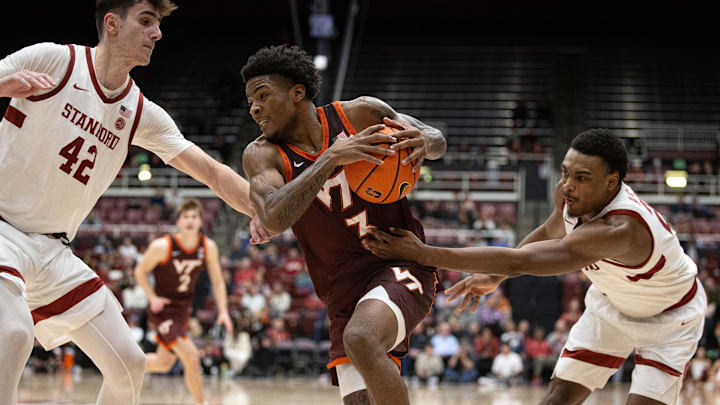 Jan 8, 2025; Stanford, California, USA; Virginia Tech Hokies guard Jaydon Young (3) drives to the basket against Stanford Cardinal defenders Maxime Raynaud (42) and Jaylen Blakes (21) during the second half at Maples Pavilion. Mandatory Credit: D. Ross Cameron-Imagn Images
