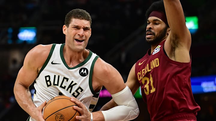 Nov 4, 2024; Cleveland, Ohio, USA; Milwaukee Bucks center Brook Lopez (11) drives to the basket against Cleveland Cavaliers center Jarrett Allen (31) during the first half at Rocket Mortgage FieldHouse. Mandatory Credit: Ken Blaze-Imagn Images