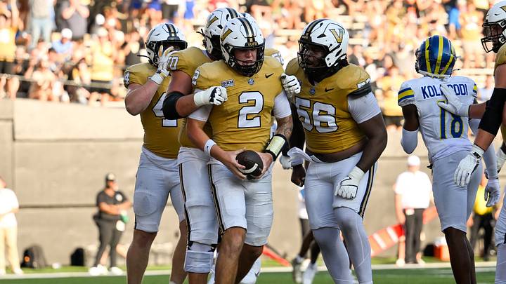 Sep 12, 2026; Nashville, Tennessee, USA; Vanderbilt Commodores quarterback Jared Curtis (2) celebrates with his teammates after scoring a touchdown against the Delaware Blue Hens during the second half at FirstBank Stadium. Mandatory Credit: Steve Roberts-Imagn Images Sep 12, 2026; Nashville, Tennessee, USA; Vanderbilt Commodores quarterback Jared Curtis (2) celebrates with his teammates after scoring a touchdown against the Delaware Blue Hens during the second half at FirstBank Stadium. Mandatory Credit: Steve Roberts-Imagn Images