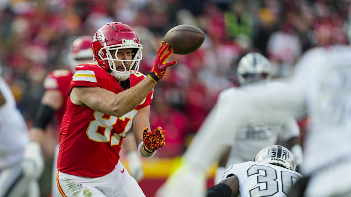 Nov 29, 2024; Kansas City, Missouri, USA; Kansas City Chiefs tight end Travis Kelce (87) laterals the ball during the first half against the Las Vegas Raiders at GEHA Field at Arrowhead Stadium. Mandatory Credit: Jay Biggerstaff-Imagn Images