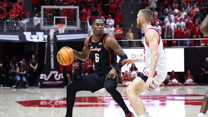 Jan 11, 2025; Salt Lake City, Utah, USA; Oklahoma State Cowboys guard Brandon Newman (6) dribbles the basketball against Utah Utes guard Mason Madsen (45) during the first half at Jon M. Huntsman Center. Mandatory Credit: Rob Gray-Imagn Images