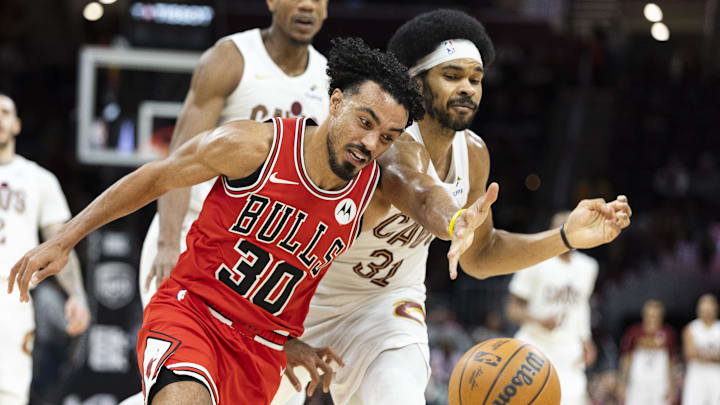 Dec 19, 2025; Cleveland, Ohio, USA; Chicago Bulls guard Tre Jones (30) holds Cleveland Cavaliers center Jarrett Allen (31) back as they battle for a loose ball during the fourth quarter at Rocket Arena. Mandatory Credit: Scott Galvin-Imagn Images