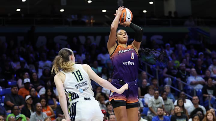 Jul 3, 2025; Arlington, Texas, USA;  Phoenix Mercury forward Satou Sabally (0) shoots over Dallas Wings center Luisa Geiselsoder (18) during the second half at College Park Center. Mandatory Credit: Kevin Jairaj-Imagn Images