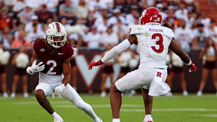 Sep 21, 2024; Blacksburg, Virginia, USA; Virginia Tech Hokies wide receiver Takye Heath (2) runs the ball against Rutgers Scarlet Knights defensive back Bo Mascoe (3) during the fourth quarter at Lane Stadium. Mandatory Credit: Peter Casey-Imagn Images