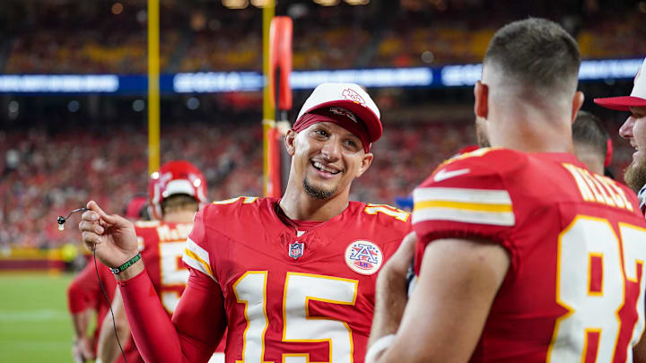 Aug 22, 2025; Kansas City, Missouri, USA; Kansas City Chiefs quarterback Patrick Mahomes (15) talks with tight end Travis Kelce (87) on  the sidelines against the Chicago Bears during the first half of the game at GEHA Field at Arrowhead Stadium. Mandatory Credit: Denny Medley-Imagn Images