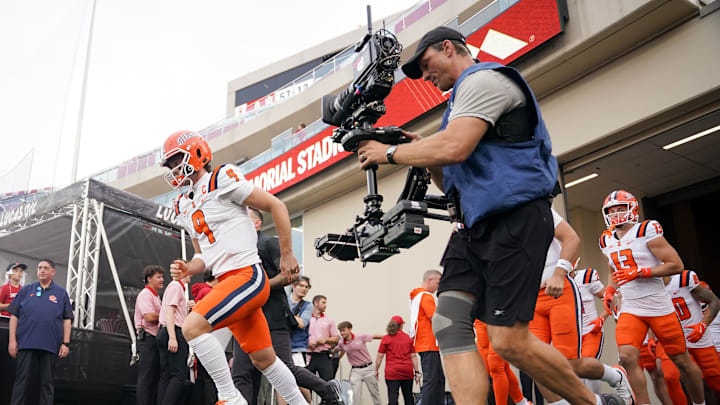 Sep 20, 2025; Bloomington, Indiana, USA; Illinois Fighting Illini quarterback Luke Altmyer (9) leads his team onto the field prior to the game against the Indiana Hoosiers at Memorial Stadium. Mandatory Credit: Robert Goddin-Imagn Images