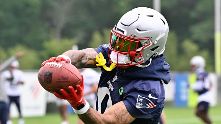 Jun 9, 2025; Foxborough, MA, USA; New England Patriots cornerback Christian Gonzalez (0) catches the ball during minicamp at Gillette Stadium. Mandatory Credit: Eric Canha-Imagn Images