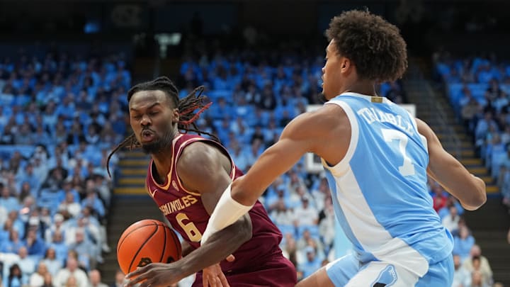 Dec 30, 2025; Chapel Hill, North Carolina, USA; Florida State Seminoles guard Robert McCray V (6) with the ball as North Carolina Tar Heels guard Seth Trimble (7) defends in the first half at Dean E. Smith Center. Mandatory Credit: Bob Donnan-Imagn Images