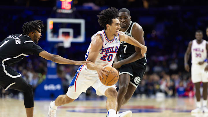 Oct 16, 2024; Philadelphia, Pennsylvania, USA; Philadelphia 76ers guard Jared McCain (20) dribbles between Brooklyn Nets Ziaire Williams (1) and guard Shake Milton (7) during the fourth quarter at Wells Fargo Center. Mandatory Credit: Bill Streicher-Imagn Images