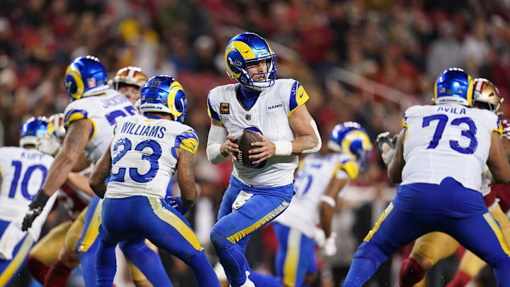 Dec 12, 2024; Santa Clara, California, USA; Los Angeles Rams quarterback Matthew Stafford (9) holds onto the ball against the San Francisco 49ers in the fourth quarter at Levi's Stadium. Mandatory Credit: Cary Edmondson-Imagn Images