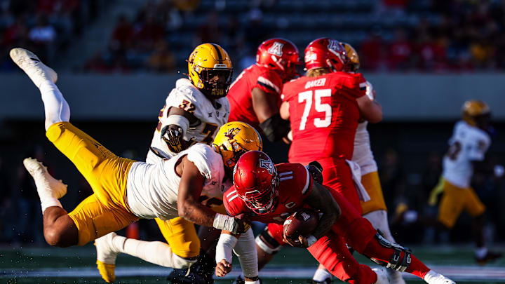 Nov 30, 2024; Tucson, Arizona, USA; Arizona Wildcats quarterback Noah Fifita (11) gets sacked by Arizona State Sun Devils defensive lineman Elijah O'Neal (15) during the fourth quarter at Arizona Stadium. Mandatory Credit: Aryanna Frank-Imagn Images
