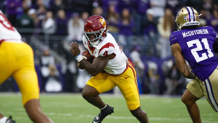 Nov 2, 2024; Seattle, Washington, USA; USC Trojans running back Woody Marks (4) rushes against the Washington Huskies during the first quarter at Alaska Airlines Field at Husky Stadium. Mandatory Credit: Joe Nicholson-Imagn Images