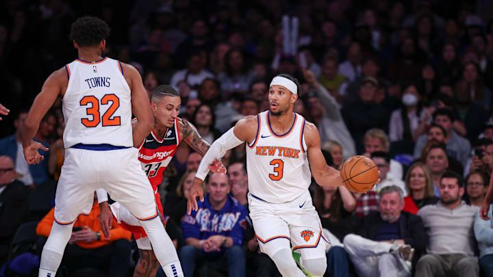 Oct 9, 2024; New York, New York, USA; New York Knicks guard Josh Hart (3) dribbles as Washington Wizards forward Kyle Kuzma (33) defends in front of center Karl-Anthony Towns (32) during the first half at Madison Square Garden. Mandatory Credit: Vincent Carchietta-Imagn Images