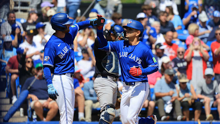 Toronto Blue Jays second baseman Andres Gimenez is congratulated after hitting a two-run home run.