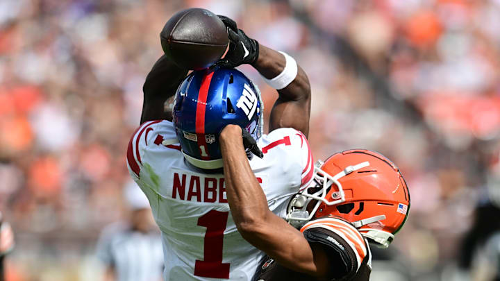 Sep 22, 2024; Cleveland, Ohio, USA; Cleveland Browns cornerback Greg Newsome II (0) breaks up a pass intended for New York Giants wide receiver Malik Nabers (1) during the second half at Huntington Bank Field.  