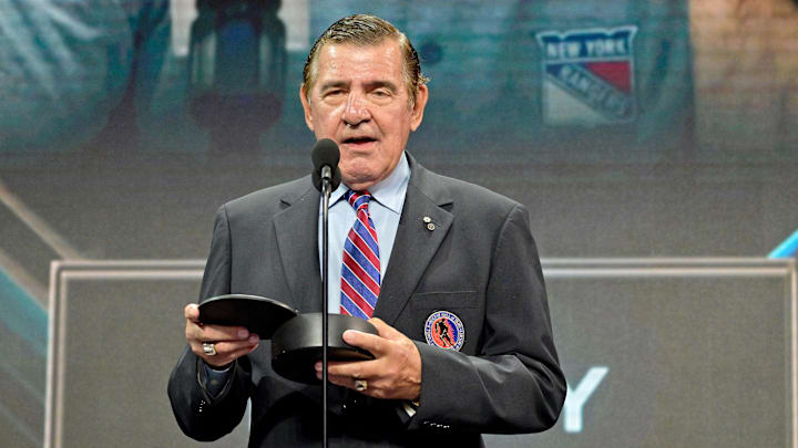 Jul 7, 2022; Montreal, Quebec, CANADA; NHL hall of famer and former Montreal Canadiens player Serge Savard presents the Jim Gregory general manager of the year award to Colorado Avalanche executive vice president and general manager Joe Sakic (not pictured) in the first round of the 2022 NHL Draft at Bell Centre. Mandatory Credit: Eric Bolte-Imagn Images