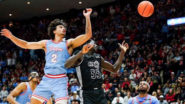 Dayton Flyers forward Nate Santos (2) and Cincinnati Bearcats forward Aziz Bandaogo (55) fail to gain possession of a loose ball in the second half of a NCAA men’s basketball game between the Cincinnati Bearcats and Dayton Flyers, Friday, Dec. 20, 2024, at Heritage Bank Center in downtown Cincinnati. Bearcats won 66-59.