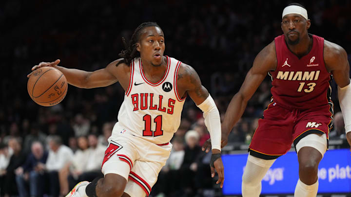Jan 31, 2026; Miami, Florida, USA; Chicago Bulls guard Ayo Dosunmu (11) drives to the basket as Miami Heat center Bam Adebayo (13) defends during the first half at Kaseya Center. Mandatory Credit: Jim Rassol-Imagn Images Jan 31, 2026; Miami, Florida, USA; Chicago Bulls guard Ayo Dosunmu (11) drives to the basket as Miami Heat center Bam Adebayo (13) defends during the first half at Kaseya Center. Mandatory Credit: Jim Rassol-Imagn Images