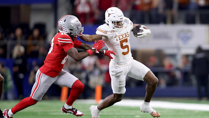 Jan 10, 2025; Arlington, Texas, USA; Texas Longhorns wide receiver Ryan Wingo (5) runs against Ohio State Buckeyes cornerback Denzel Burke (10) during the first quarter of the College Football Playoff semifinal in the Cotton Bowl at AT&T Stadium. Mandatory Credit: Tim Heitman-Imagn Images
