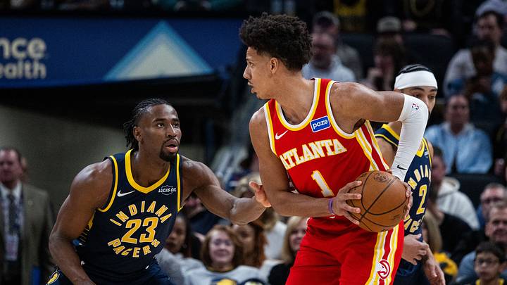 Jan 31, 2026; Indianapolis, Indiana, USA; Atlanta Hawks forward Jalen Johnson (1) holds the ball while Indiana Pacers guard/forward Aaron Nesmith (23) defends in the first half at Gainbridge Fieldhouse. Mandatory Credit: Trevor Ruszkowski-Imagn Images