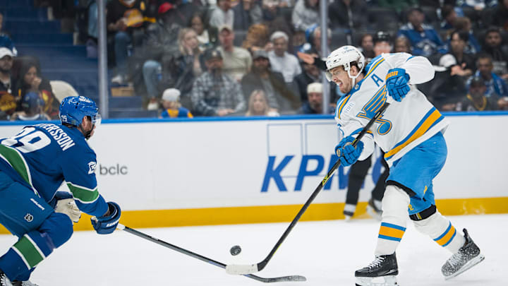 Oct 13, 2025; Vancouver, British Columbia, CAN; Vancouver Canucks defenseman Marcus Pettersson (29) stick checks St. Louis Blues forward Robert Thomas (18) in the third period at Rogers Arena. Mandatory Credit: Bob Frid-Imagn Images