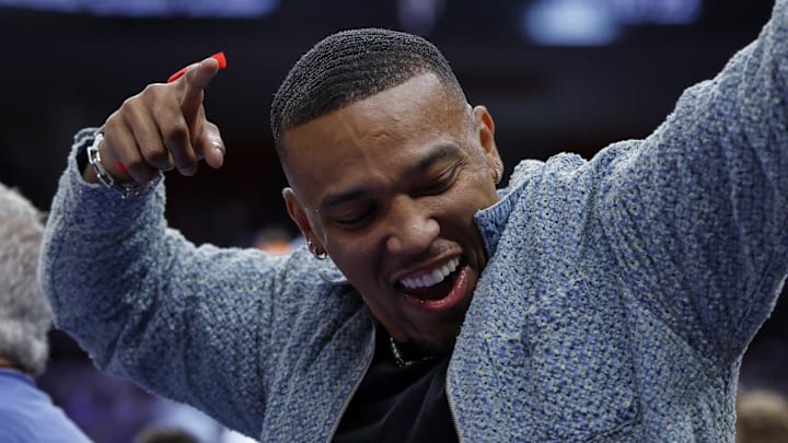 Apr 24, 2025; Detroit, Michigan, USA; Detroit Lions Amon-Ra St. Brown cheers during the second half of the game between the Detroit Pistons and the New York Knicks during game three of first round for the 2024 NBA Playoffs at Little Caesars Arena. Mandatory Credit: Rick Osentoski-Imagn Images