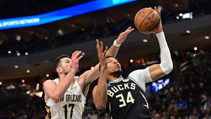 Apr 10, 2025; Milwaukee, Wisconsin, USA; Milwaukee Bucks forward Giannis Antetokounmpo (34) and New Orleans Pelicans forward Karlo Matkovic (17) reach for a rebound in the second quarter at Fiserv Forum. Mandatory Credit: Benny Sieu-Imagn Images