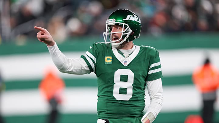 Jan 5, 2025; East Rutherford, New Jersey, USA; New York Jets quarterback Aaron Rodgers (8) gestures towards the Miami Dolphins bench during the second half at MetLife Stadium. Mandatory Credit: Vincent Carchietta-Imagn Images
