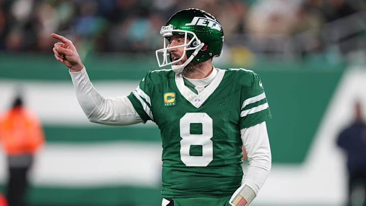 Jan 5, 2025; East Rutherford, New Jersey, USA; New York Jets quarterback Aaron Rodgers (8) gestures towards the Miami Dolphins bench during the second half at MetLife Stadium. Mandatory Credit: Vincent Carchietta-Imagn Images