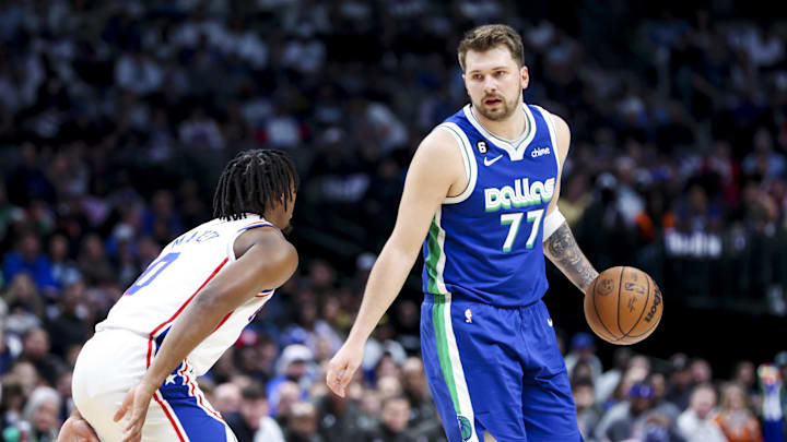 Mar 2, 2023; Dallas, Texas, USA;  Dallas Mavericks guard Luka Doncic (77) looks to drive as Philadelphia 76ers guard Tyrese Maxey (0) defends during the first quarter at American Airlines Center. Mandatory Credit: Kevin Jairaj-Imagn Images