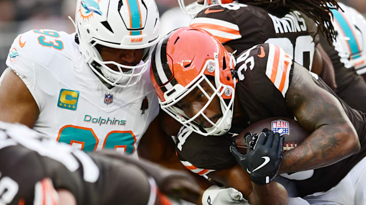 Dec 29, 2024; Cleveland, Ohio, USA; Miami Dolphins defensive tackle Calais Campbell (93) tackles Cleveland Browns running back Jerome Ford (34) during the first half at Huntington Bank Field. Mandatory Credit: Ken Blaze-Imagn Images