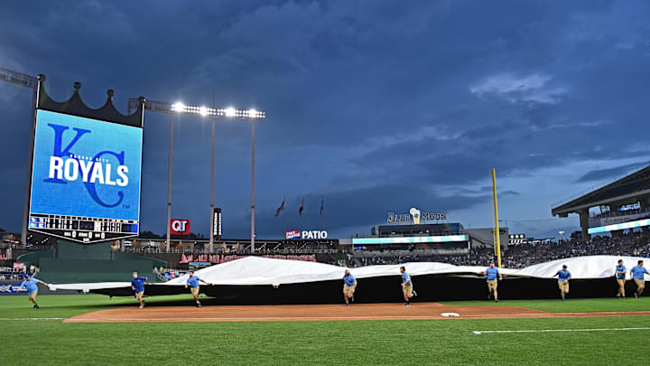 Jul 2, 2024; Kansas City, Missouri, USA;  The field crew run out the field tarp during a rain delay in the fifth inning between the Kansas City Royals and Tampa Bay Rays at Kauffman Stadium. Mandatory Credit: Peter Aiken-Imagn Images
