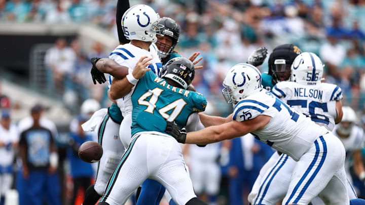 Oct 6, 2024; Jacksonville, Florida, USA; Jacksonville Jaguars defensive end Travon Walker (44) forces a fumble by Indianapolis Colts quarterback Joe Flacco (15) in the second quarter at EverBank Stadium. Mandatory Credit: Nathan Ray Seebeck-Imagn Images