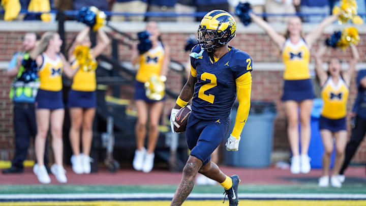 Michigan defensive back Will Johnson (2) celebrates a touchdown after intercepting USC quarterback Miller Moss (7) during the second half at Michigan Stadium in Ann Arbor on Saturday, Sept. 21, 2024.